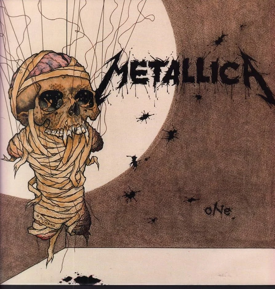 Metallica – One: illustriertes Cover mit bandagiertem Schädel und Metallica-Schriftzug.